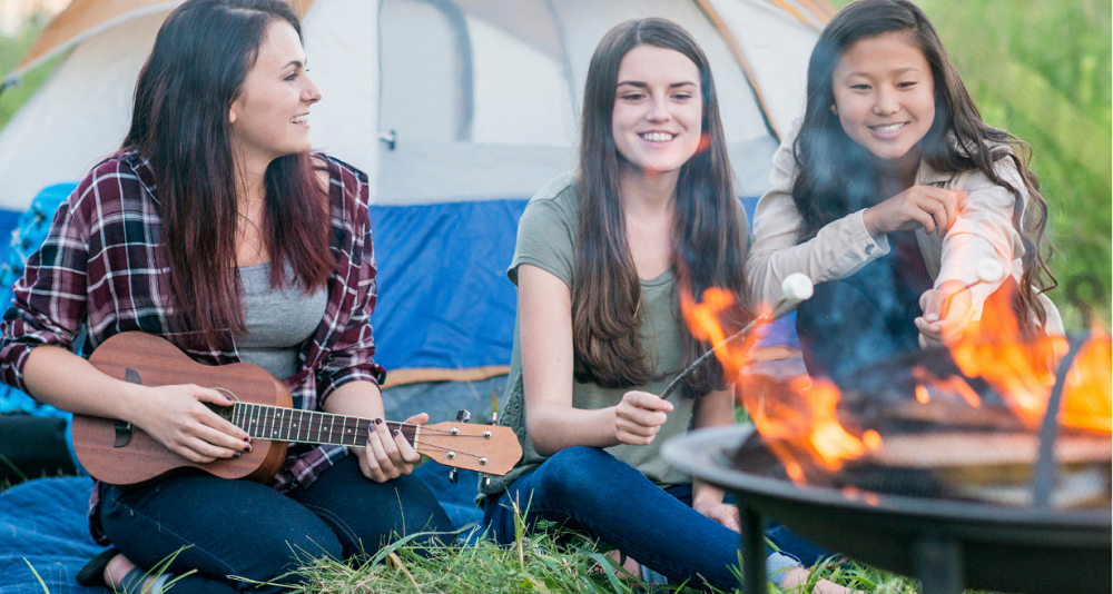 Play the ukuele at the campfire.