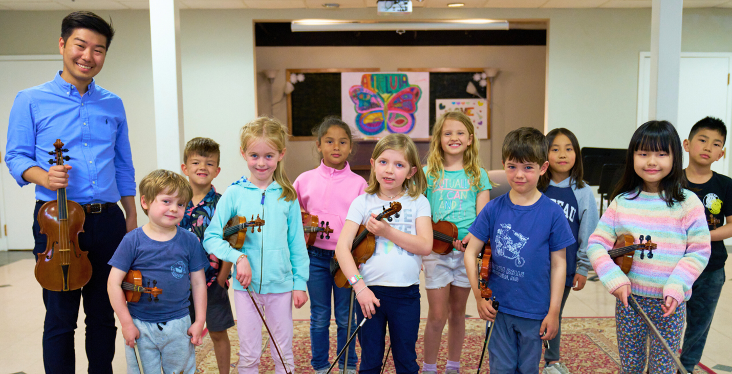 CCM faculty Member Long Okada with West Side String Kids